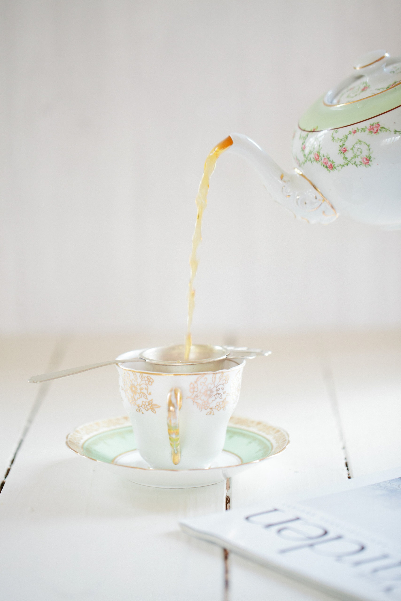 Tea being poured in tea cup