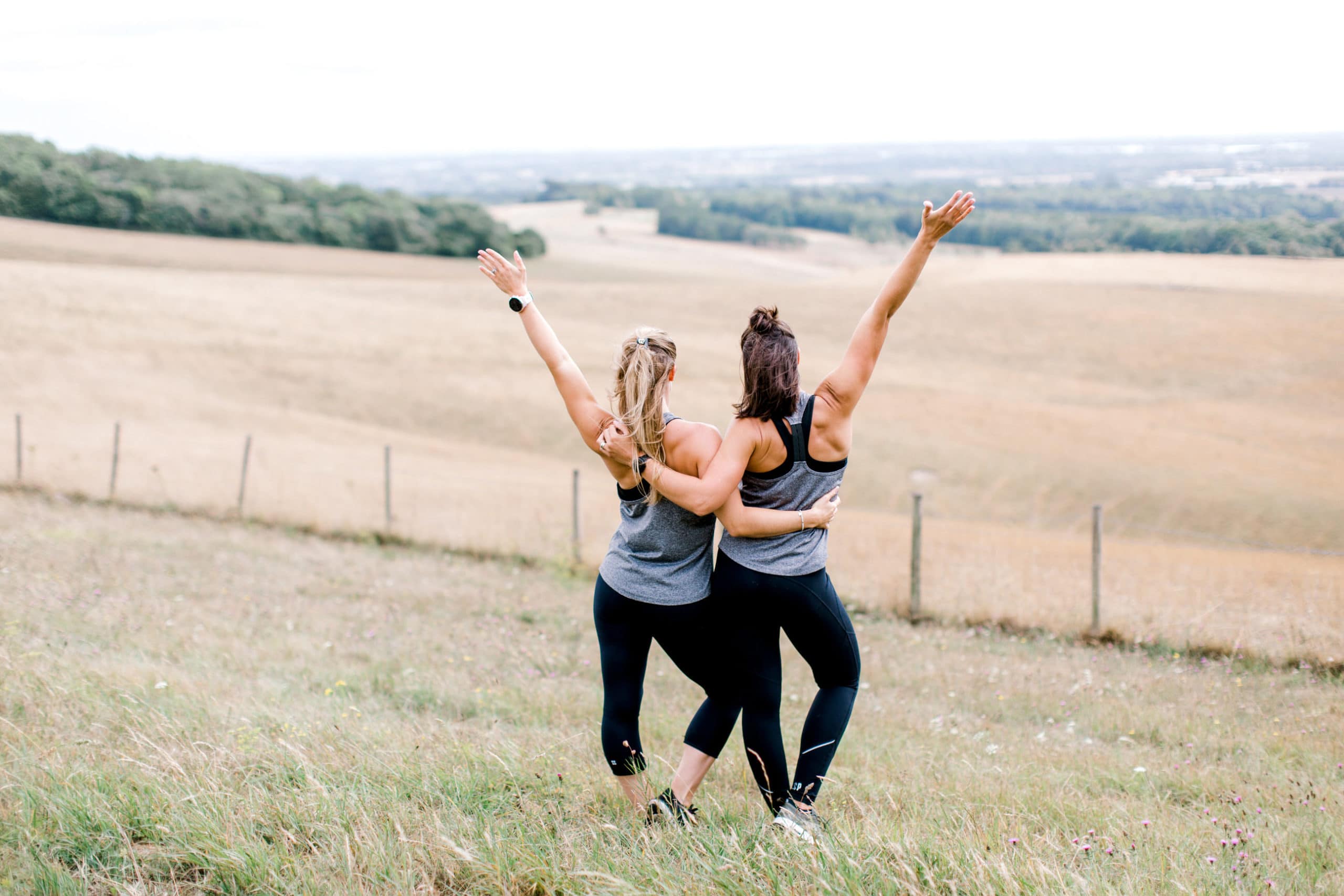 two women raising their arms