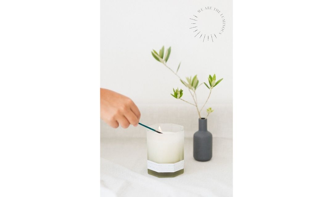 hand lighting scented candle