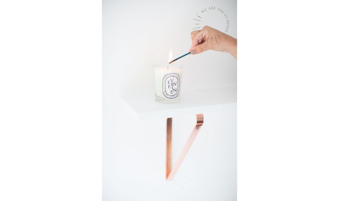 hand lighting scented candle stock photography