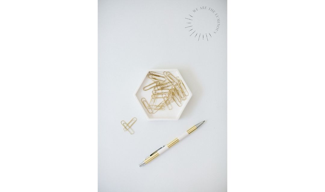 gold paperclips with pen