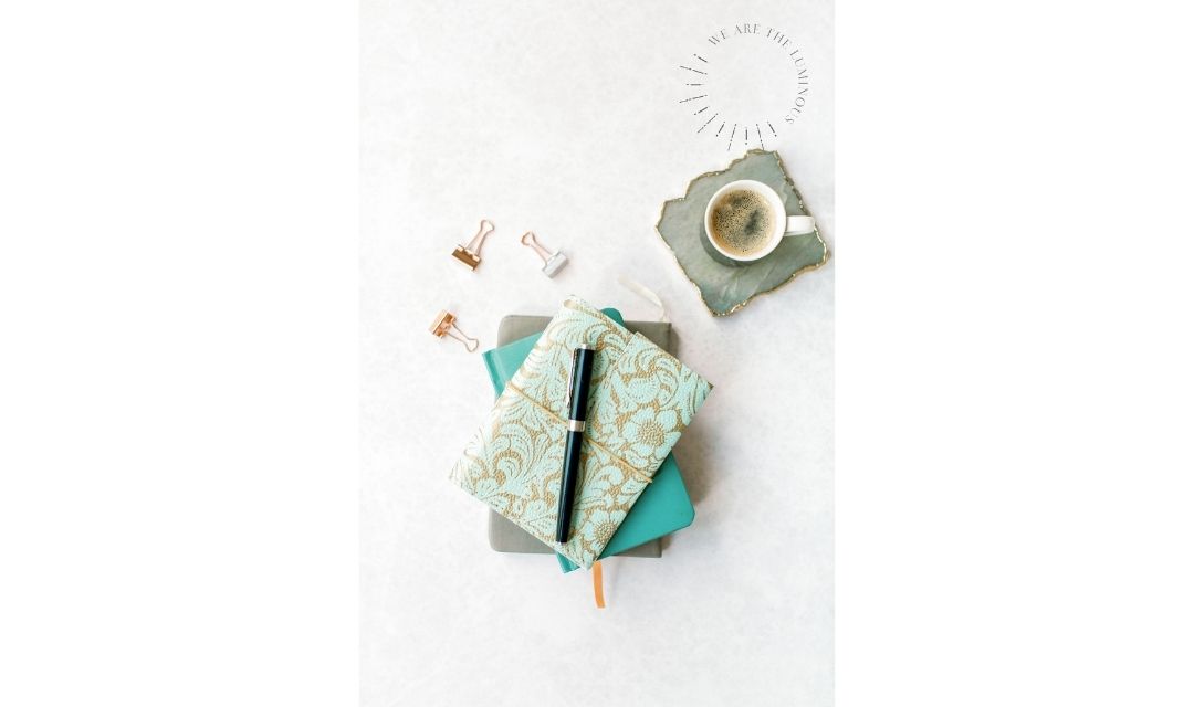 turquoise note book with pen and coffee