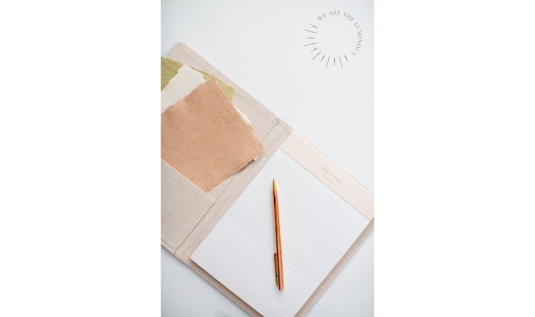 pink notebook and pen