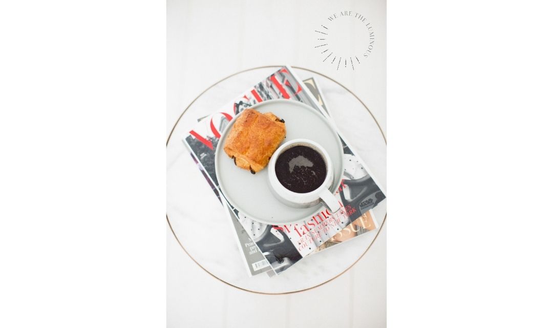 coffee and croissant on a magazine