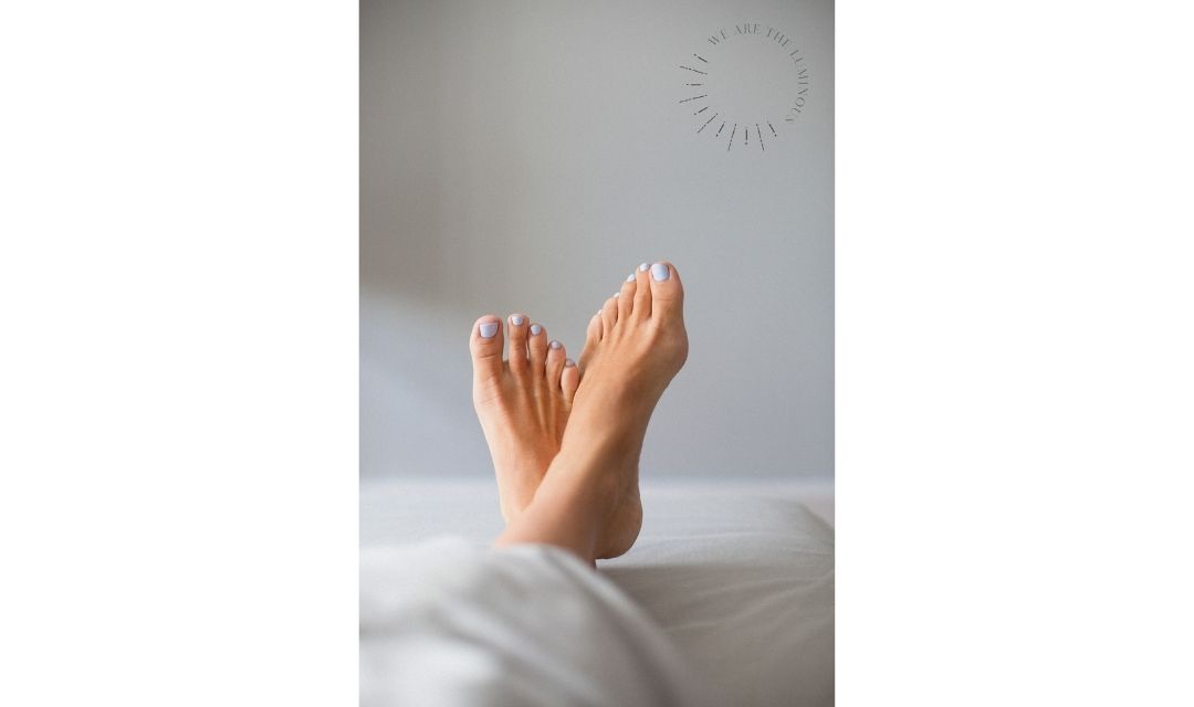 feet in bed stock photo