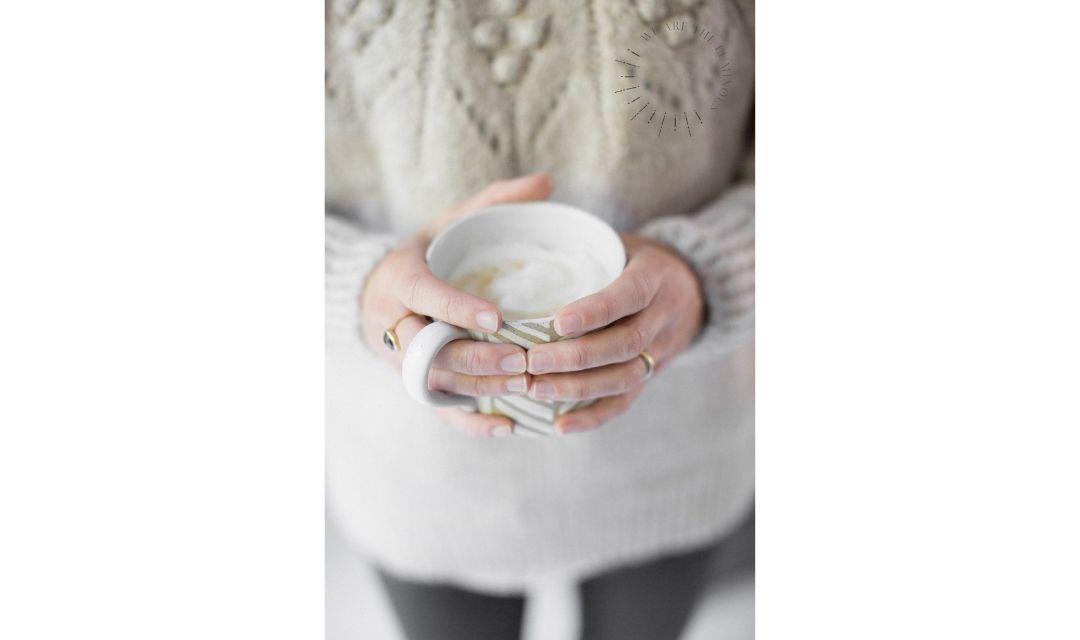 hands holding a cup of coffee