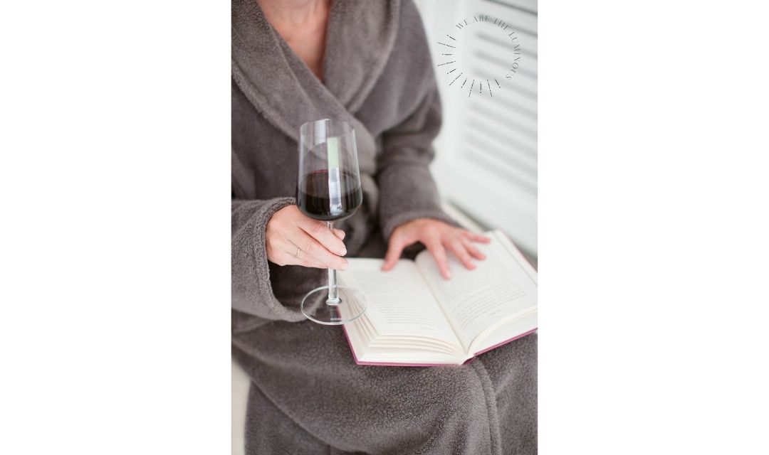 woman holding a glass of red wine stock photo