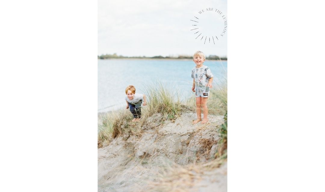 Children playing in sand dunes