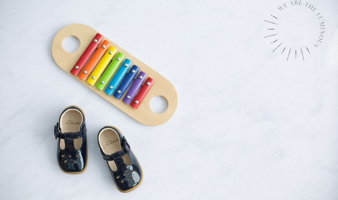 child's shoes with rainbow glockenspiel