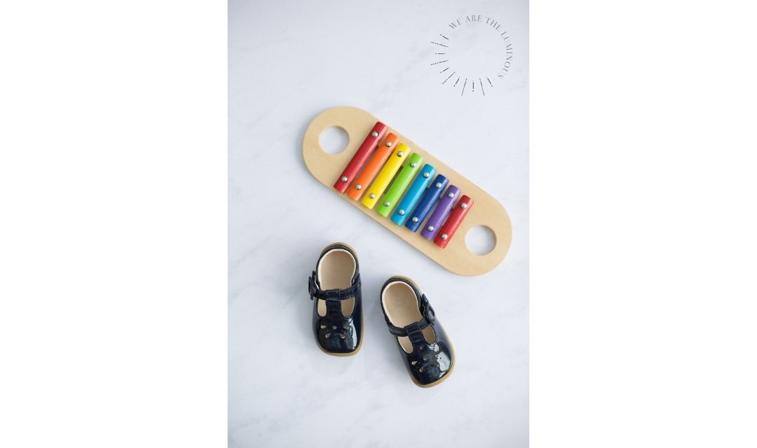child's shoes with rainbow glockenspiel