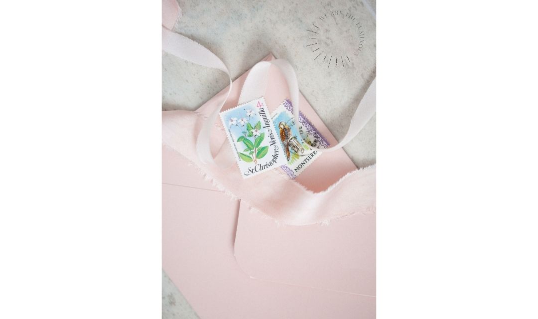 pink envelope with stamps