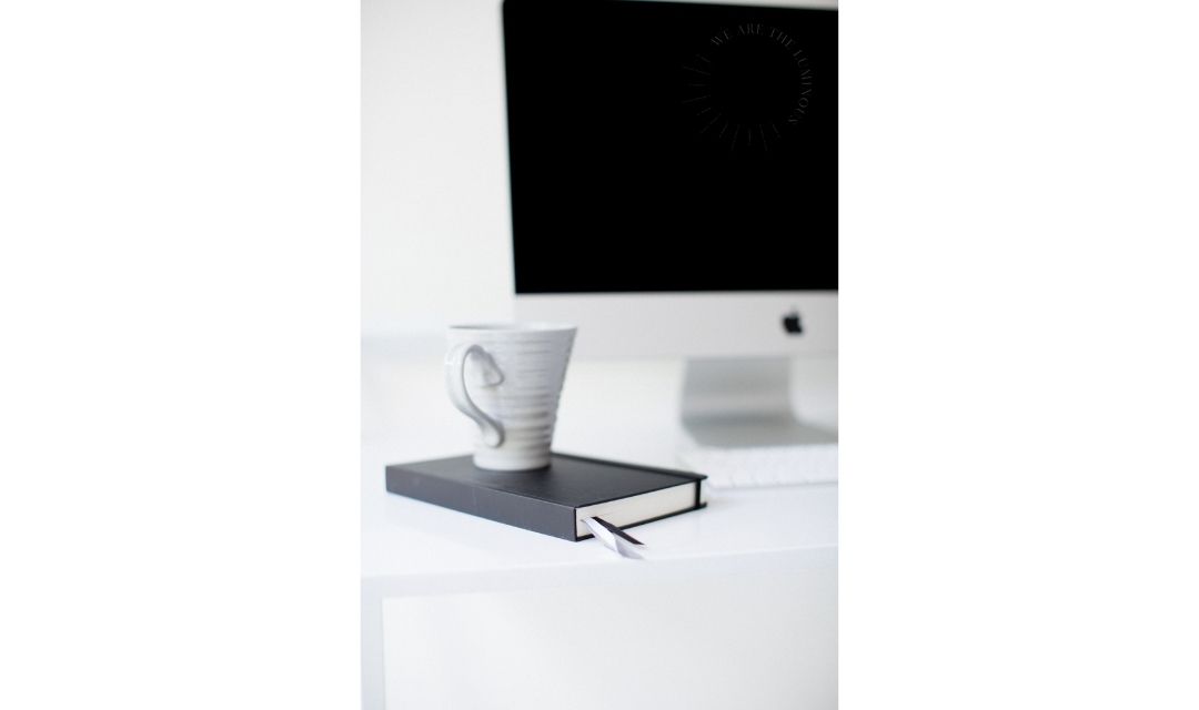 cup of coffee next to computer