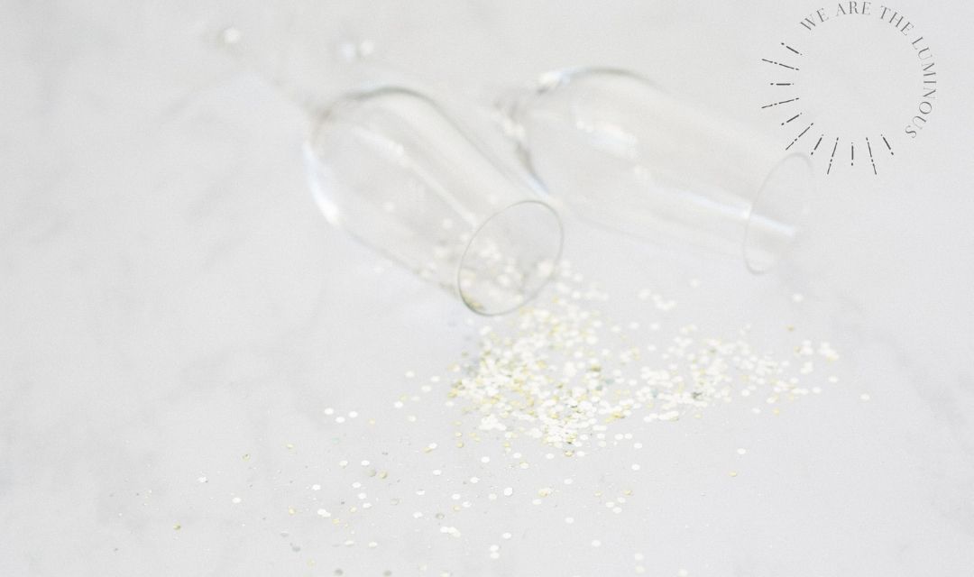 two champagne glasses with gold glitter
