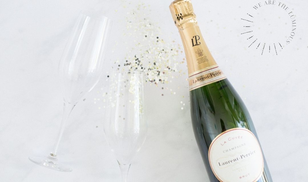 two champagne glasses and bottle of champagne styled stock photography