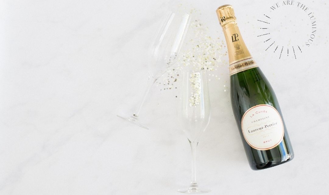 two champagne glasses and bottle of champagne styled stock photography