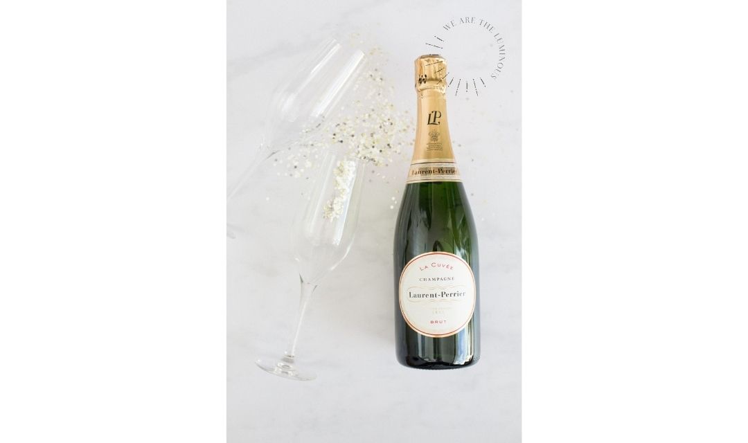 two champagne glasses and bottle of champagne styled stock photography