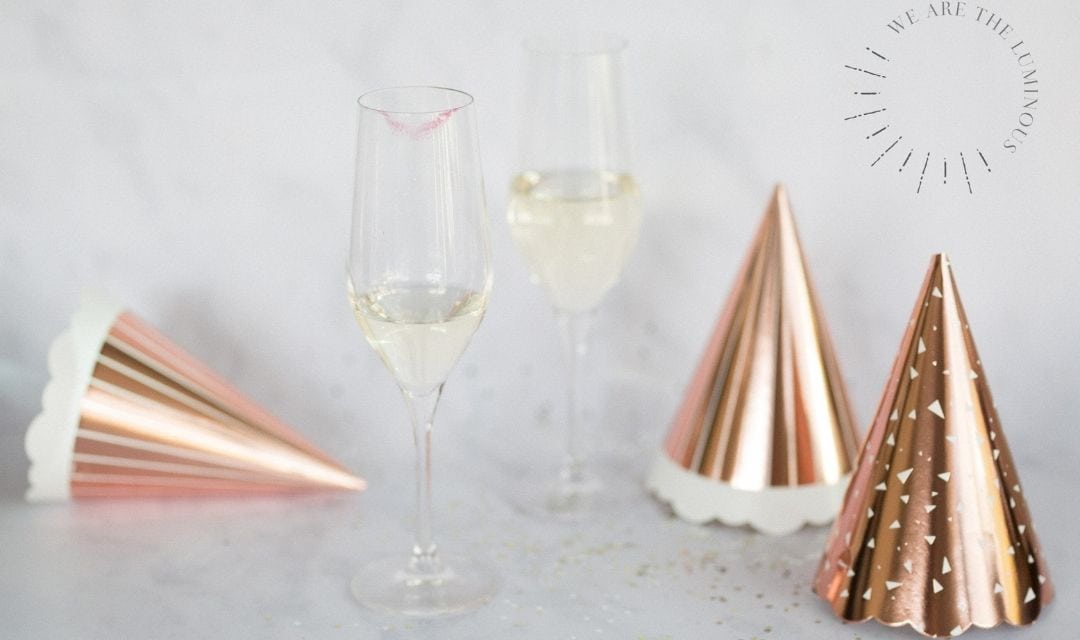 two champagne glasses and party hats
