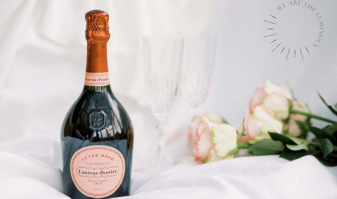 bottle of pink champagne with roses