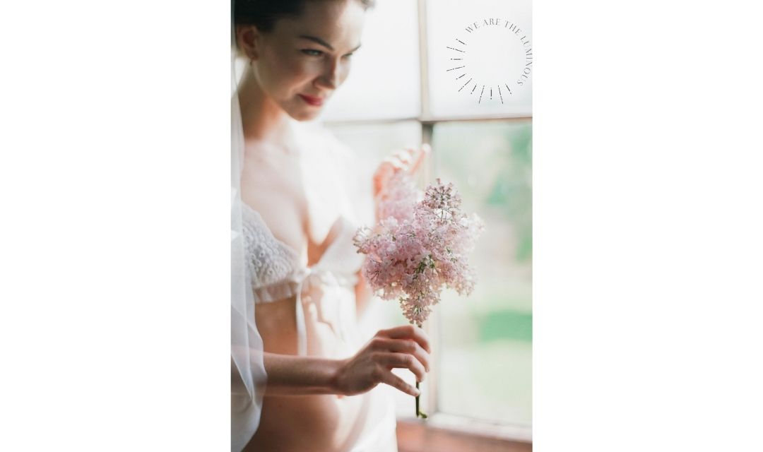 woman holding lilac flower