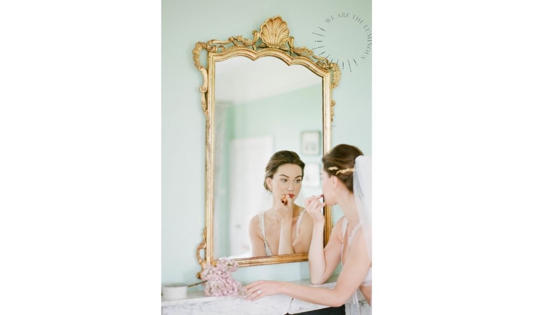 A bride getting ready applying lipstick